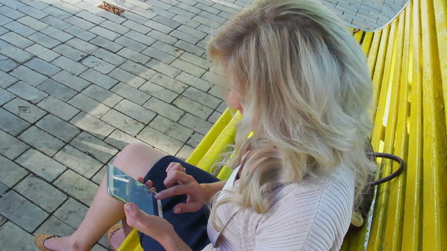 Top view young woman writes sms message on smart