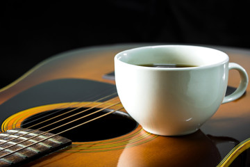 Steel string acoustic guitar with coffee cup
