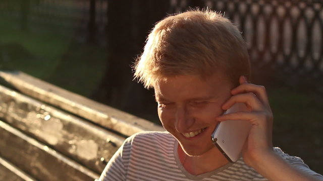 Happy young male calling over phone enjoying, good relationships