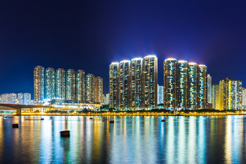 Fototapeta na wymiar Apartment building in Hong Kong at night