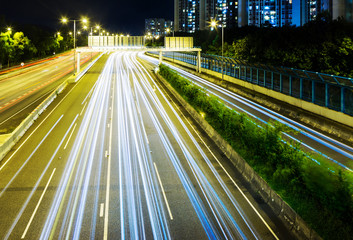Fototapeta na wymiar Busy traffic on highway at night