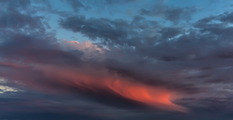 Dramatic sunset with red cloud.