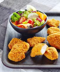 chicken nuggets and fresh vegetable salad