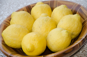 lemons in the fruit bowl on wood