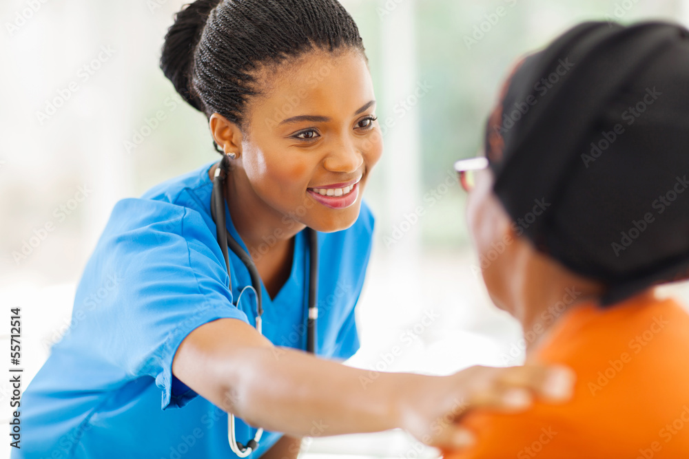 Wall mural african medical nurse comforting senior patient