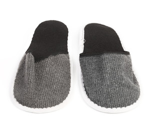 Pair of gray slippers on a white background.