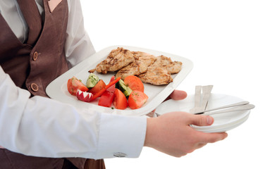 Waiter is offering grilled meat and vegetables