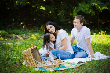 Daughter hugs with mother. Picnic