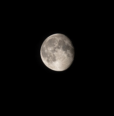 Detailed waning moon on a dark sky.