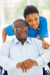 elderly african american man and caring young caregiver