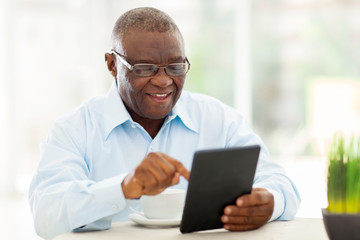 senior african american man using tablet computer at home
