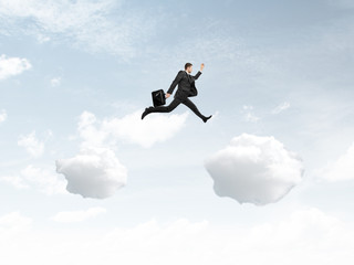 man jumping from cloud