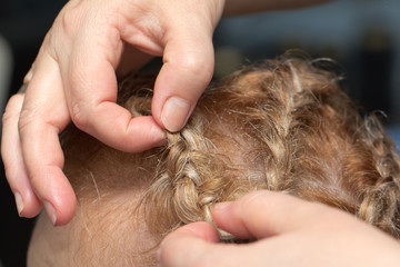 braided hairstyle of hair in a beauty salon