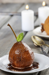 Pear with chocolate sauce. French dessert. Selective focus