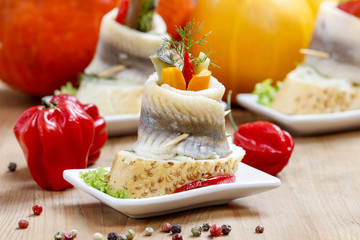 Pickled herring rolls with vegetables