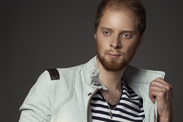 Obraz premium a guy with a beard in a denim jacket
