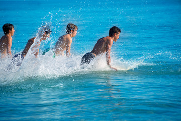 Boys surfers surfing running jumping on surfboards