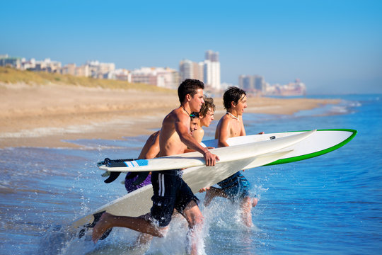 Boys Surfers Surfing Running Jumping On Surfboards