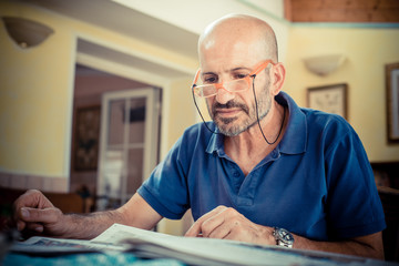 miggle age man reading newspaper