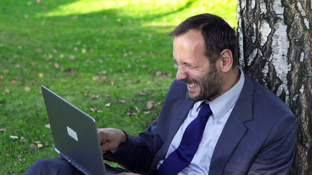 Angry businessman with laptop, super slow motion shot at 240fps