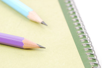 Pencils on green notebooks