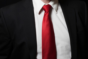Man in shirt an suit with red tie