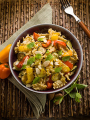 pasta with capsicum zucchinis and sliced almond