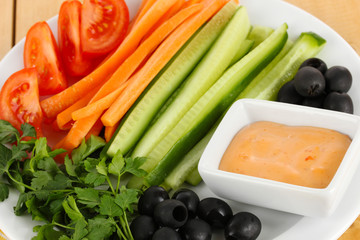 Assorted raw vegetables sticks in plate close up