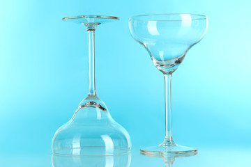 Two glasses on light blue background