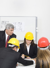 Architects working in office on construction project