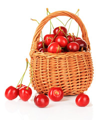 Cherry berries in wicker basket isolated on white