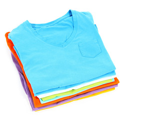 Neatly folded shirts isolated on white