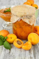 Apricot jam in glass jar and fresh apricots,