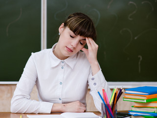 tired teacher in classroom