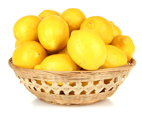 Ripe lemons in wicker basket isolated on white
