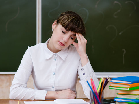 Tired Teacher In Classroom