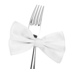 White bow tie  on fork, isolated on white