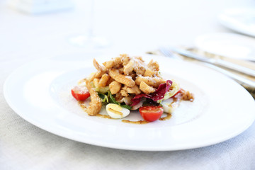 Caesar salad on white plate, close up