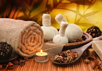 Fototapeten Massage background with rolled towel, spa balls and candlelight © gtranquillity
