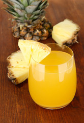 Delicious pineapple juice on table close-up