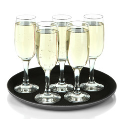 Many glasses of champagne on the tray, isolated on white