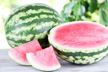 Ripe watermelons on wooden table on nature background