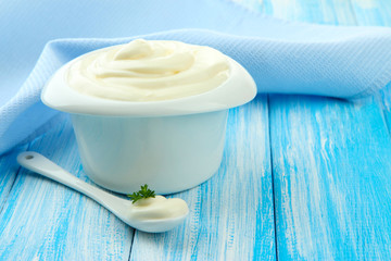 Sour cream in bowl on table close-up