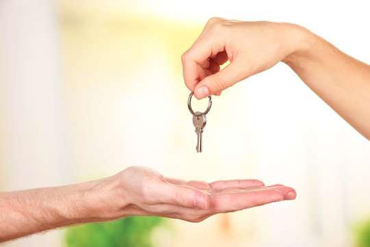 Transfer of house key, on bright background