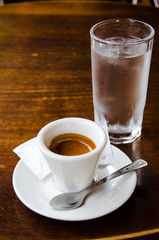 White espresso cup with glass of cold water on the wooden table - 55743509