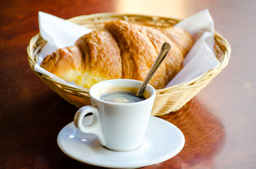 Cup of espresso with croissant