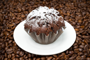 chocolate muffin on a background of coffee beans