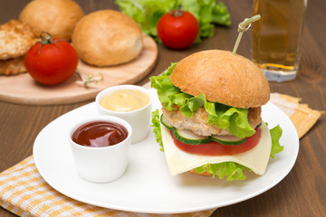 homemade chicken burger with ketchup and mustard