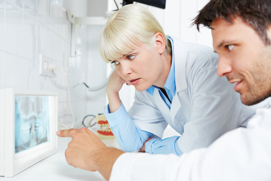 Radiologist and dentist examine panoramic radiograph