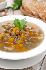 vegetable soup with lentils in a plate, close-up